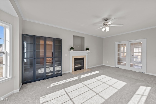 unfurnished living room with plenty of natural light, carpet, and french doors