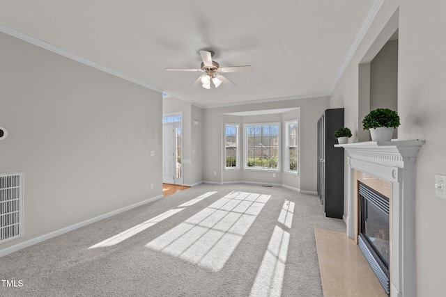 unfurnished living room with light carpet, a premium fireplace, visible vents, baseboards, and ornamental molding