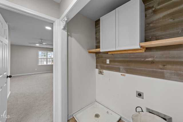 laundry area with carpet flooring, a ceiling fan, baseboards, cabinet space, and electric dryer hookup