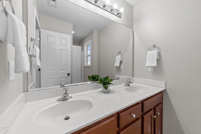 full bathroom with double vanity, a sink, and visible vents