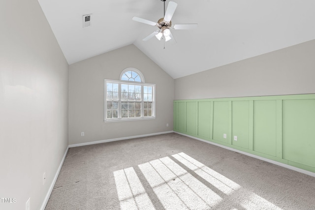 bonus room with carpet, a wainscoted wall, visible vents, vaulted ceiling, and ceiling fan