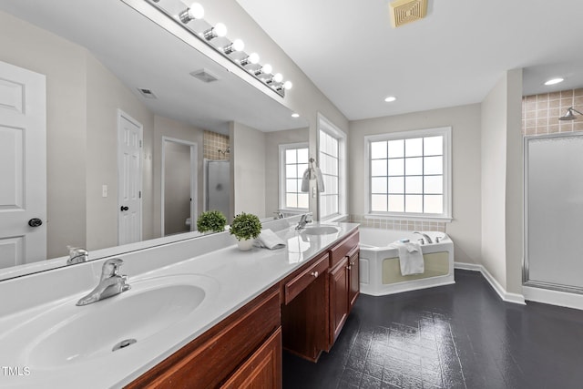 full bathroom with a stall shower, visible vents, a sink, and a garden tub