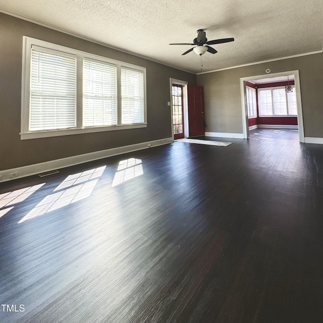 unfurnished living room with visible vents, dark wood finished floors, and crown molding