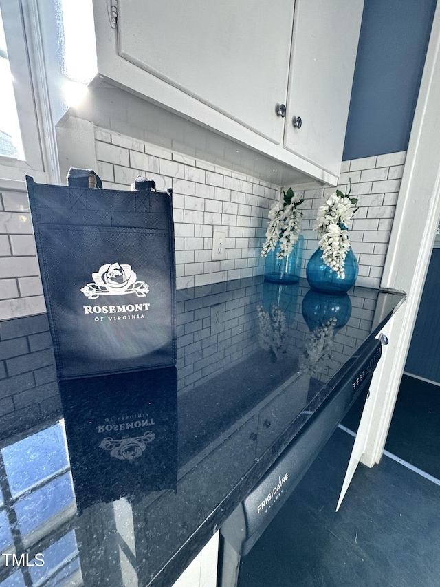 interior details with dark countertops and white cabinets