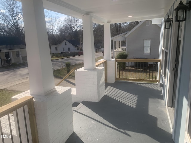 view of patio featuring covered porch and a residential view