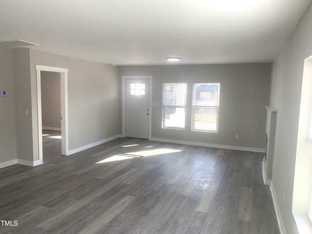 entrance foyer featuring dark wood-style flooring, visible vents, and baseboards