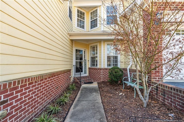 property entrance with brick siding