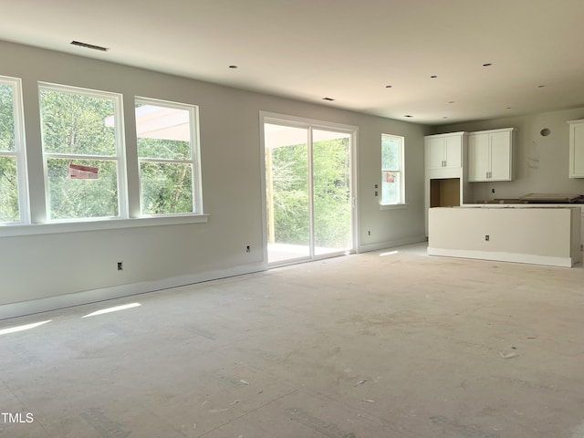212 Fast Pitch Ln, Four Oaks, NC 27524 - unfurnished living room with healthy amount of natural light and baseboards