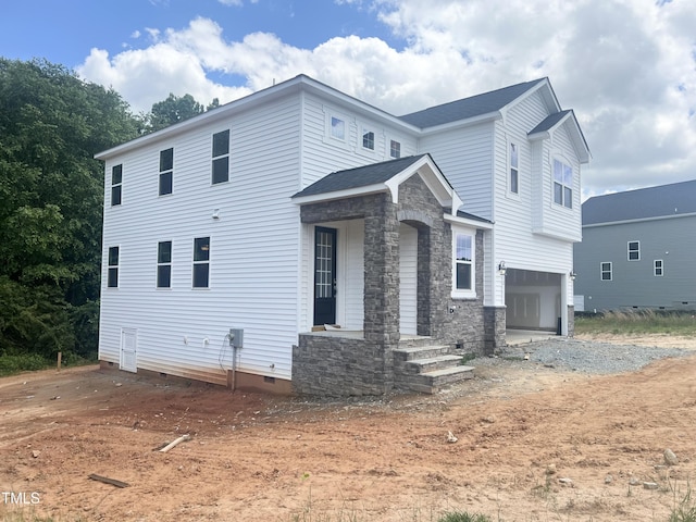 212 Fast Pitch Ln, Four Oaks, NC 27524 - view of front of house featuring an attached garage, crawl space, stone siding, and dirt driveway