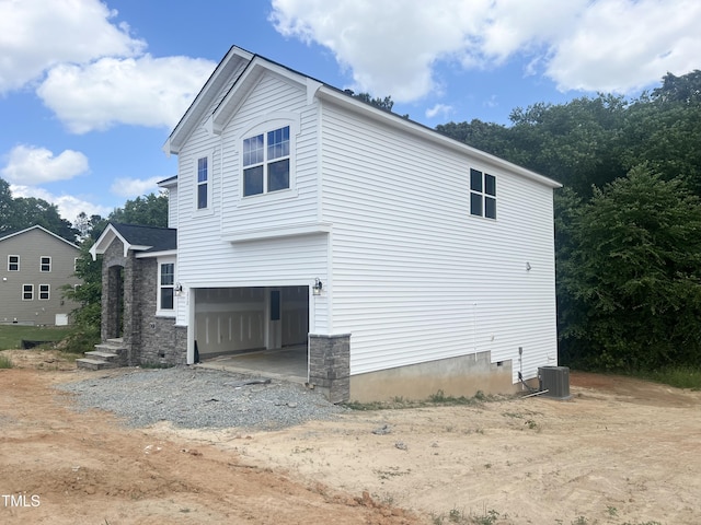 212 Fast Pitch Ln, Four Oaks, NC 27524 - view of home's exterior featuring a garage, driveway, and central AC