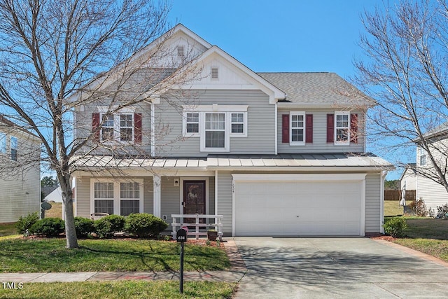 traditional home with covered porch, concrete driveway, a standing seam roof, metal roof, and a garage