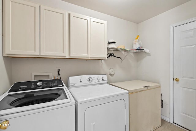 laundry room with cabinet space and separate washer and dryer