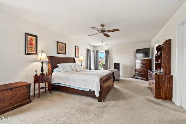 bedroom with visible vents, a ceiling fan, and light colored carpet