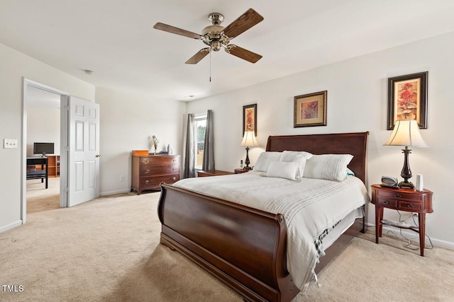 bedroom with light carpet, ceiling fan, and baseboards