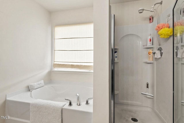 bathroom featuring a stall shower and a garden tub