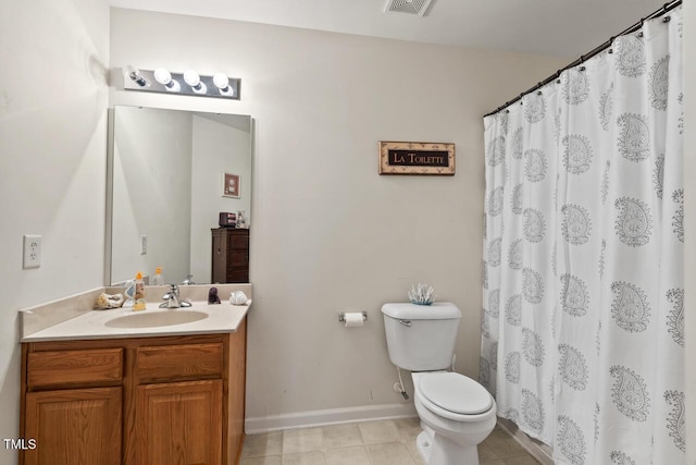 bathroom featuring toilet, visible vents, vanity, baseboards, and tile patterned floors