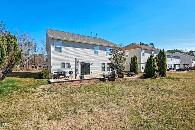 back of house with an outdoor fire pit, a lawn, and a patio