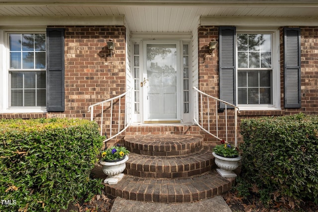 property entrance featuring brick siding