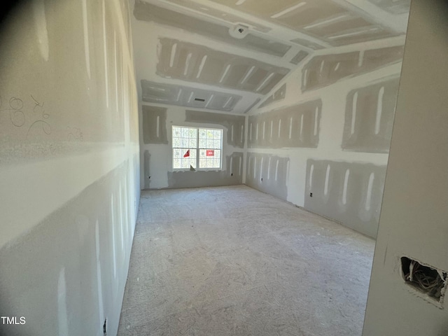 unfurnished room with vaulted ceiling