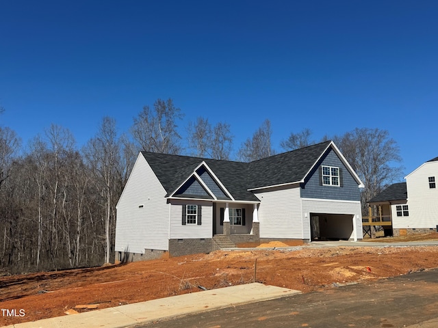 view of front facade featuring crawl space, roof with shingles, and an attached garage