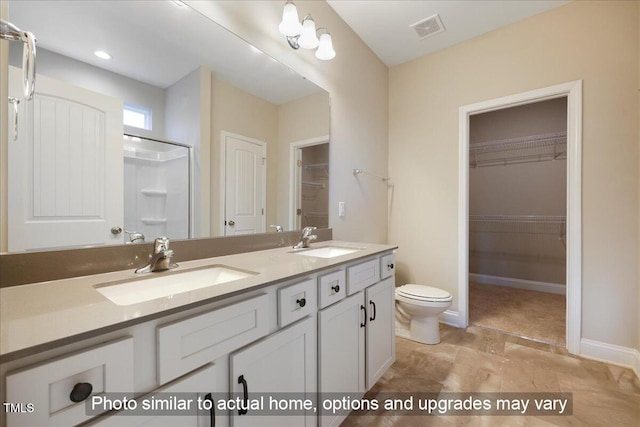 full bathroom featuring toilet, double vanity, a sink, and visible vents