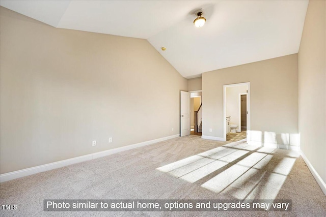 unfurnished room featuring vaulted ceiling, carpet flooring, and baseboards