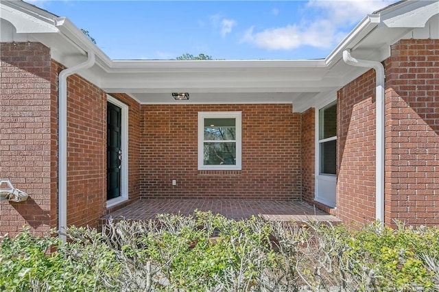 entrance to property with brick siding