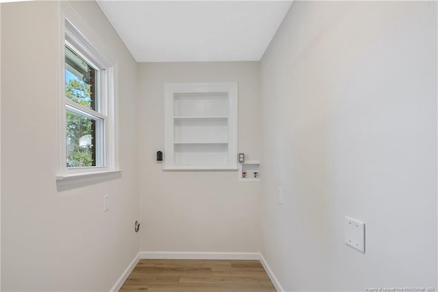 washroom with laundry area, washer hookup, light wood-style flooring, and baseboards