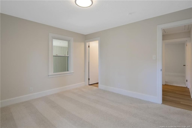 empty room with carpet and baseboards