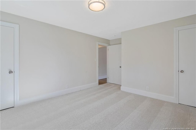 unfurnished bedroom featuring carpet and baseboards