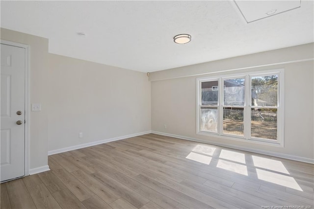 unfurnished room featuring light wood finished floors and baseboards