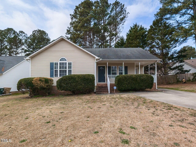 single story home with fence, a front lawn, and a porch