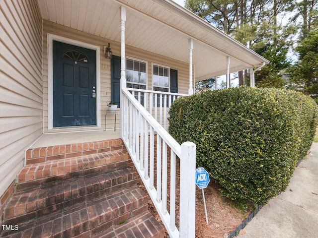 view of exterior entry with covered porch