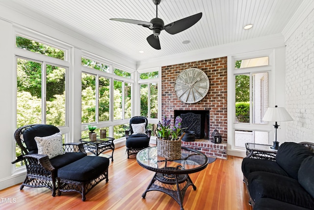 interior space featuring wood ceiling, a fireplace, and a ceiling fan