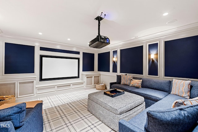 cinema room featuring a decorative wall, crown molding, and recessed lighting