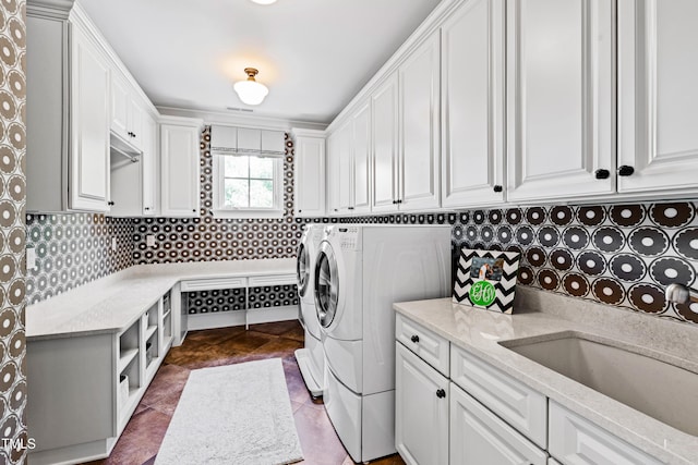 laundry room with washer and clothes dryer, tile patterned flooring, a sink, and cabinet space