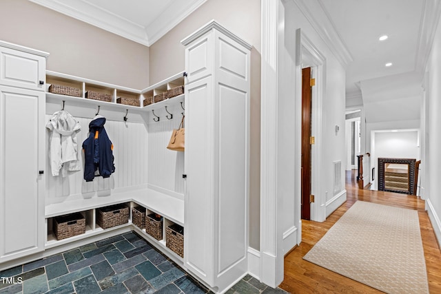 mudroom featuring recessed lighting, visible vents, ornamental molding, dark wood-type flooring, and baseboards