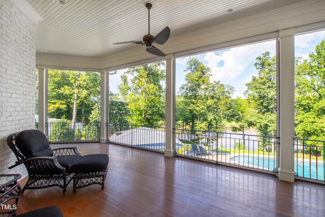 sunroom / solarium featuring ceiling fan