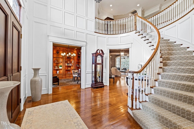 foyer with a decorative wall and an inviting chandelier