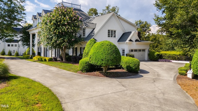 view of front of home with driveway, an attached garage, and stucco siding