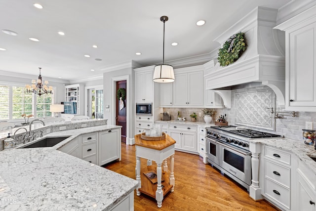 kitchen featuring range with two ovens, a sink, custom exhaust hood, built in microwave, and crown molding