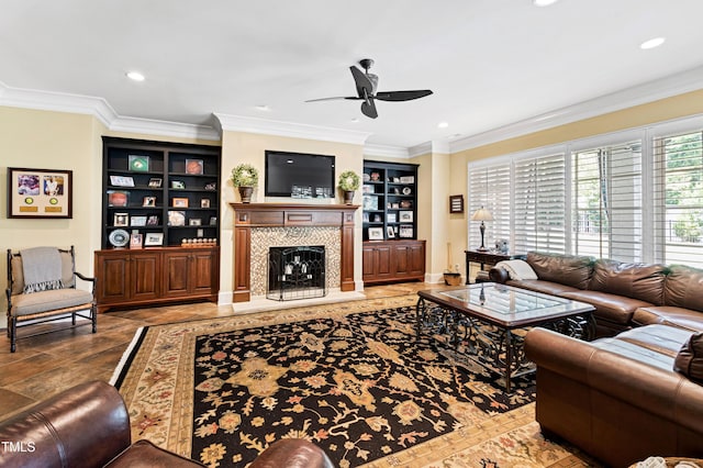 living room with built in shelves, ornamental molding, a fireplace with raised hearth, and recessed lighting