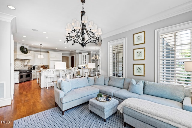 living area featuring recessed lighting, a notable chandelier, dark wood-type flooring, visible vents, and crown molding