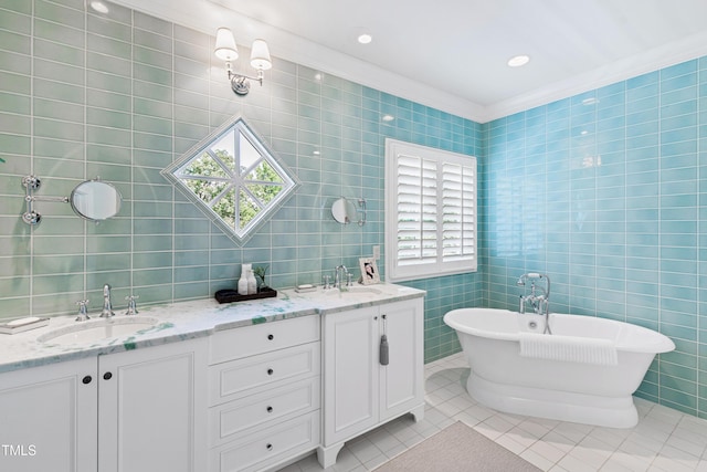 bathroom with a soaking tub, a sink, tile walls, and tile patterned floors