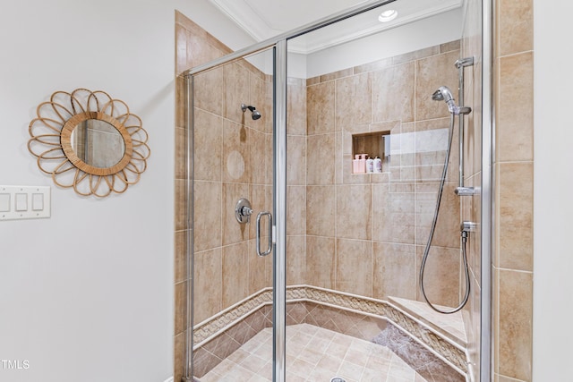 bathroom featuring ornamental molding and a stall shower