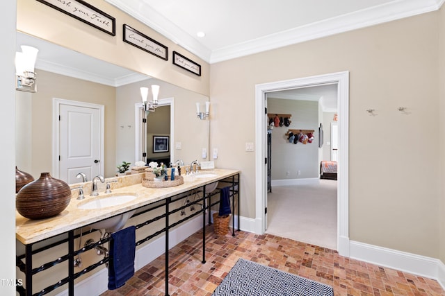 full bath featuring double vanity, crown molding, baseboards, and a sink