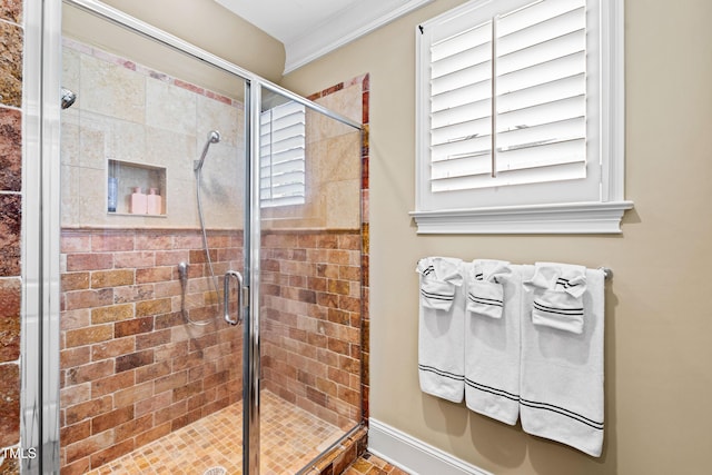 full bathroom with a shower stall, ornamental molding, and baseboards