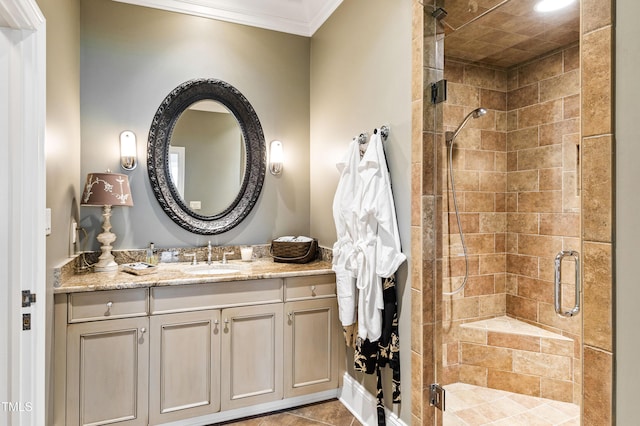 bathroom featuring a stall shower, ornamental molding, and vanity