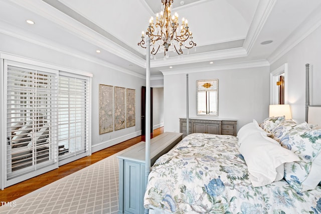 bedroom featuring recessed lighting, wood finished floors, ornamental molding, a raised ceiling, and an inviting chandelier