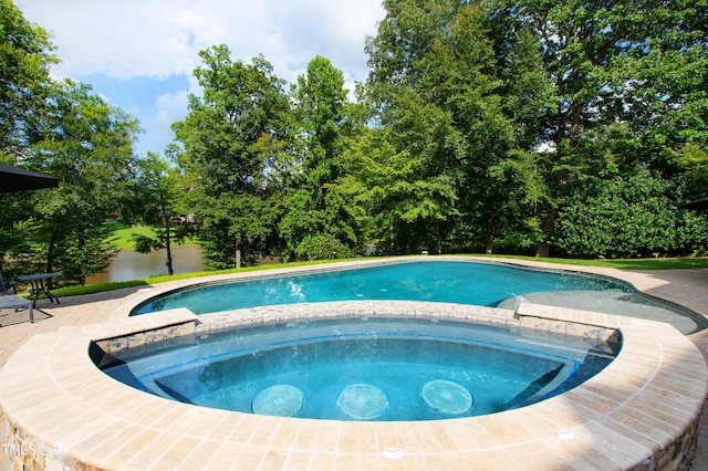 view of swimming pool featuring a pool with connected hot tub